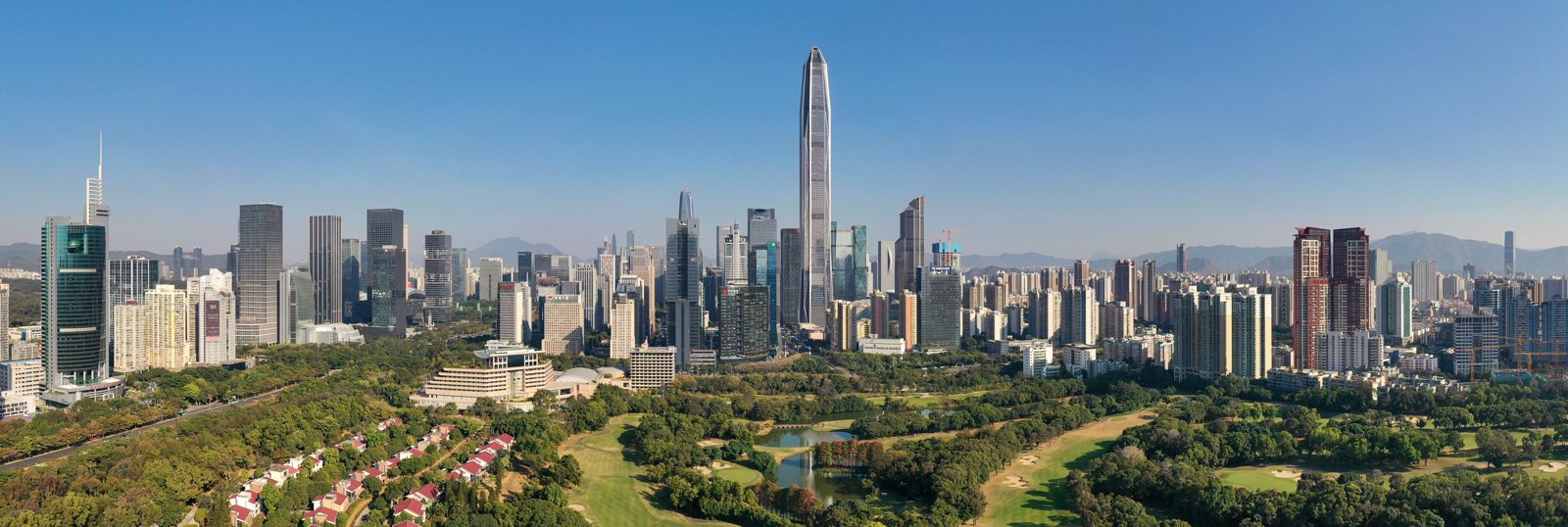 Shenzhen’s Futian skyline and Ping An Finance Center above green parkland.